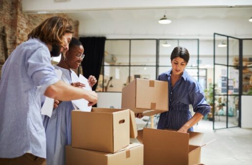 People unpacking boxes in an office.